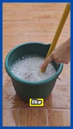 a person using a plunger to clean a bowl of water on the tile floor