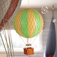 a hot air balloon in the shape of a ballon is suspended from a ceiling