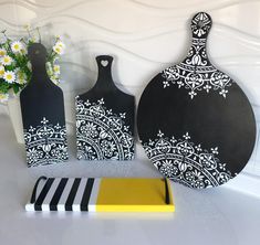 three black and white vases sitting next to each other