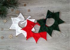 three christmas decorations on a wooden table