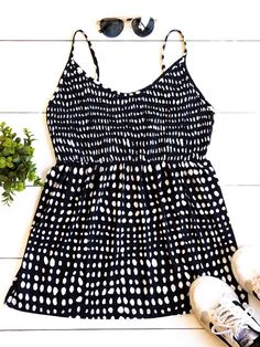 Cute, simple, and stylish... need we say more. The smocked top, beautiful pattern, and soft fabric make this tank stand out in a crowd. Note: Smocking is only on the front of the tank. The back is solid. Size Small 0-4 Medium 6-8 Large 10-12 XL 12-14 Sleeveless Polka Dot Tops For Vacation, Casual Polka Dot Tank Top, Chic Polka Dot Tank Top For Summer, Sleeveless Polka Dot Top For Beach, Sleeveless Smocked Back Tank Top For Vacation, Sleeveless Tank Top With Smocked Back For Vacation, Chic Polka Dot Tank Top For Spring, Spring Chic Polka Dot Tank Top, Casual Spring Tank Top With Smocked Back