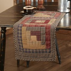 a wooden table with a plaid runner on it