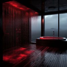 a red bath tub sitting inside of a bathroom next to a large glass window on top of a wooden floor