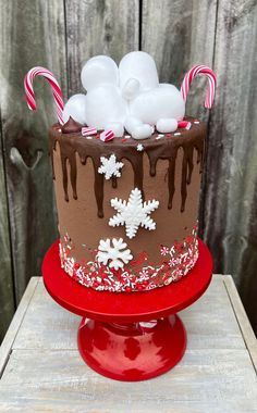 a chocolate cake decorated with candy canes and marshmallows