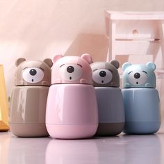 four little bears are lined up in the same color and shape as they appear to be made out of plastic