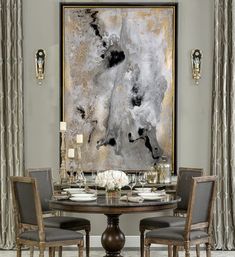 a dining room table with four chairs and a large painting on the wall behind it