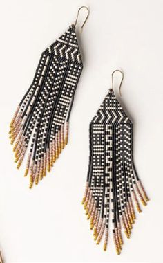 two pairs of black and white beaded earrings with fringes on the ends, one is