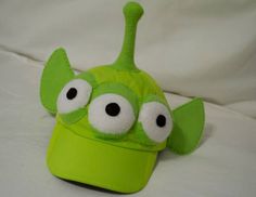 a green hat with googly eyes on it