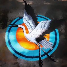 a white bird flying over a blue target with an orange circle in the background that says city arts