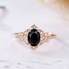 a black and white diamond ring sitting on top of a table