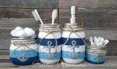 three mason jars with toothbrushes and toothpaste in them