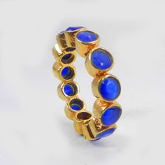 Handmade Blue Cats Eye Gemstone Ring- Gold Plated Brass Ring- Eternity Band Ring- Stackable Ring- Women's Ring- Engagement Ring for Women Description : ~ Material : Brass & Gemstone ~ Gemstone : Synthetic Blue Cat's Eye ~ Gemstone Shape : Round ~ Stone Size : 4 mm Approx ~ Ring Weight : 3.69 Gram Approx ~ Setting Type : Bezel ❣❣ Handmade Item ❣❣ **Made to Order** » G E M S T O N E S D E T A I L S « **Gemstone structure may vary from the image as two gemstones do not have the same structure** Adjustable Blue Stackable Rings For Anniversary, Adjustable Blue Stackable Crystal Ring, Adjustable Stackable Rings With Stone Setting, Blue Stackable Crystal Ring For Anniversary, Blue Bezel-set Ring Jewelry, Blue Stackable Toe Rings, Adjustable Blue Rings With Bezel Setting, Adjustable Blue Ring With Bezel Setting, Adjustable Blue Crystal Ring