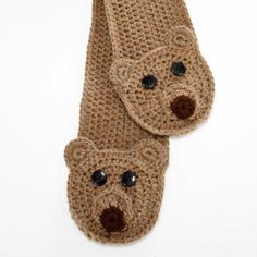 two crocheted teddy bears are attached to a tie