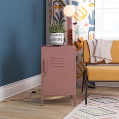 A modern room features a pink Cache Metal Locker End Table by Novogratz with a potted plant next to a mustard yellow chair. Colorful abstract curtains complement the geometric rug Locker Designs, Door Metal, End Table With Storage, Living Room Setup, Metal End Tables, Metal Lockers, Living Room End Tables, Living Room Side Table, Living Room Collections