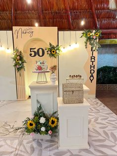 a white table topped with a cake and flowers