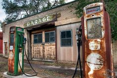 an old rusty gas pump sitting in front of a building