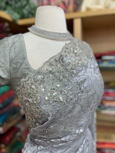 Our beautiful Net Fabric Party Wear Saree in grey color features intricate lace work, perfect for adding a touch of sophistication and grace to your special occasion. Order now and make a statement with your stunning look! Elegant Evening Sets With Lace Work, Elegant Lace Work Party Set, Elegant Party Sets With Lace Work, Wedding Party Wear Blouse With Intricate Embroidery, Silver Dress With Resham Embroidery For Party, Silver Resham Embroidery Party Dress, Elegant Silver Dress With Resham Embroidery, Silver Gown With Resham Embroidery For Party, Wedding Party Wear Saree With Pearl Embroidery