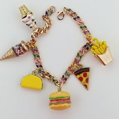 This Whimsical Delights Charm Bracelet is a delectable celebration of your favorite things in a delightful wearable form. This enchanting bracelet is a feast for the eyes, adorned with  enamel charms that showcase your most cherished treats: ice cream, a juicy hamburger, crispy fries, a classic pizza slice, taco and  playful bubble gum balls. The ice cream cone captures the sweetness of your fondest memories, while the hamburger, fries, taco and pizza charms bring to mind the joy of indulging in Hamburger Fries, Crispy Fries, Granite City, Classic Pizza, Food Charms, Whimsical Jewelry, Assemblage Necklace, Button Bracelet, Unusual Jewelry