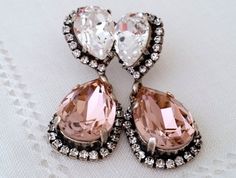 #weddings #jewelry #earrings #bridesmaidgift #swarovskiearrings #chandelierearrings #statementearrings #dangleearrings #dropearrings #crystalearrings #rhinestoneearrings #bridalwedding #blushpink #blushandclear #peachearrings Wedding Dangle Earrings With Jewels, Jeweled Dangle Earrings For Wedding, Glamorous Drop Chandelier Earrings As Gift, Glamorous Drop Chandelier Earrings For Gift, Pink Drop Crystal Earrings For Wedding, Glamorous Teardrop Crystal Earrings For Gift, Wedding Pink Sparkling Crystal Earrings, Pink Sparkling Crystal Earrings For Wedding, Bridal Earrings Studs