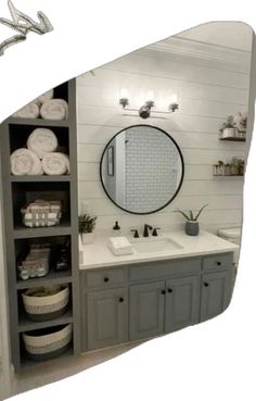 the bathroom is decorated in white and gray colors with lots of storage space for towels