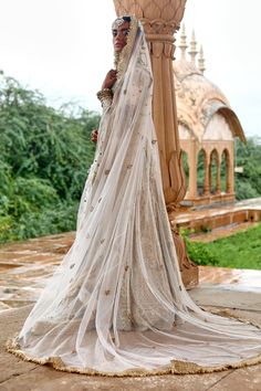 Off white raw silk lehenga with all over gold zardosi and aari embroidery. Paired with all over embroidered leaf neck blouse, butterfly net dupatta and fringe tasselled border veil.
Components:4
Pattern:Woven and Embroidered
Type of Work:Zardozi and Aari Work
Neckline:Leaf Neck
Sleeve Type:Half Sleeves
Fabric:Raw Silk, Veil: Butterfly Net, Dupatta: Butterfly Net, Lining: Shantoon
Color:Off White
Other Details:
Embellished border
Cut work hem on lehenga
Butti pattern net dupatta and veil
Closure: Silk Veil, Embroidered Leaf, Raw Silk Lehenga, Butterfly Net, Embroidered Leaves, Types Of Work, Aari Embroidery, Luxury Sale, Silk Lehenga