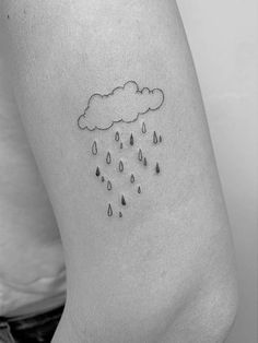 a black and white photo of a woman's lower leg with rain drops on it