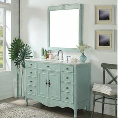 a bathroom vanity with a large mirror above it