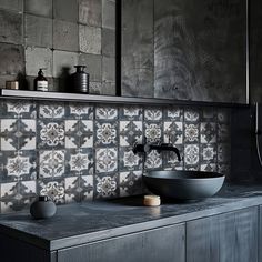 a bathroom sink sitting under a mirror on top of a wooden cabinet next to a counter