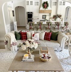 a living room filled with furniture and christmas decorations