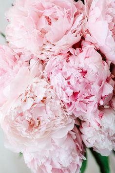 a bouquet of pink peonies in a vase