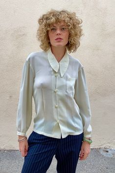 Vintage Matsuda White Shirt With Asymmetrical Collar in wonderful condition. This semi-sheer creamy button down is elegant with vintage flair. A timeless beauty. Comfortable and versatile. Made in Japan. dry clean only. 100% polyester. Best fits size S/M. Approx Measurements: Underarm to underarm: 17" across Length: 25" White Silk Button-up Shirt, Classic White Silk Shirt, Semi-formal White Silk Blouse, White Silk Blouse For Semi-formal Occasions, White Silk Blouse With Spread Collar, White Silk Top For Semi-formal Occasions, White Silk Shirt With Button Closure, Elegant Beige Shirt With Spread Collar, Cream Collared Office Blouse