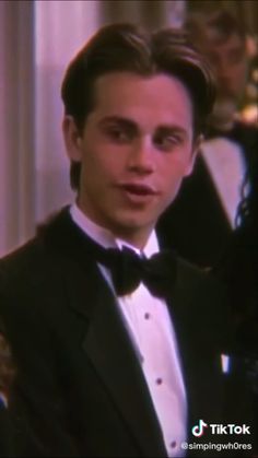 a young man in a tuxedo and bow tie