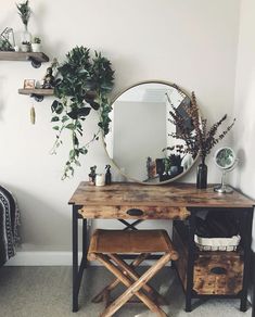 a wooden table topped with a mirror next to a chair and potted plant on top of it