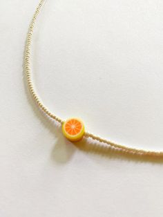 The Grapefruit Pearl Necklace is a playful and refreshing twist on everyday jewelry. This minimalist piece features a delicate string of tiny ivory pearls, accented by a single vibrant grapefruit charm. The whimsical citrus design adds a splash of color and character, making it perfect for those who appreciate simplicity with a touch of fun. Key Features Adjustable gold-tone clasp. Features tiny Ivory pearls. Instructions Avoid contact with water and harsh chemicals to preserve material integrit Adjustable Summer Beaded Necklaces With Pearl Charm, Adjustable Beaded Pearl Charm Necklaces For Summer, Adjustable Orange Single Strand Beaded Necklace, Trendy Adjustable Beaded Necklaces With Pearl Charm, Adjustable Pearl Necklace Summer Gift, Adjustable Orange Necklace For Summer, Adjustable Pearl Necklace For Summer Gift, Summer White Jewelry With Fruit Design, Trendy Adjustable Orange Beaded Necklaces