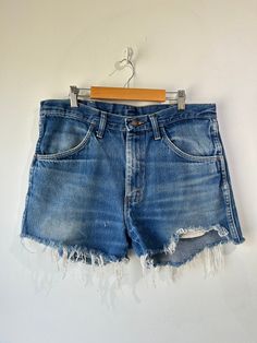 Vintage Rustler Denim Cut-Off Shorts. Worn in and faded with great fringe at the hem. Machine wash regular and lay flat to dry. Size W 33". Approximate measurements:Waist: 33" Inseam: 3"Length: 12.5" High Rise Medium Wash Bottoms With Frayed Hem, Medium Wash Bottoms With Frayed Hem And Short Leg, Medium Wash Short Leg Bottoms With Frayed Hem, Short Leg Bottoms With Frayed Hem In Medium Wash, Summer Bottoms With Dark Wash And Unfinished Hem, Pre-washed Denim Bottoms For Summer, Summer Denim Bottoms Pre-washed, Summer Pre-washed Denim Bottoms, Relaxed Fit Medium Wash Pre-washed Bottoms