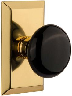 the door knob is shiny gold and has a dark brown handle