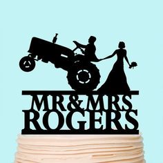 a wedding cake topper with an image of a tractor and bride on it's side