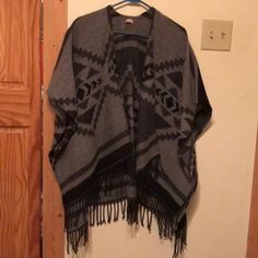 Black And Grey Poncho Never Been Worn Brand New Without Tags Thought I Was Going To Wear It And Took The Tags Off. Casual Black Poncho For Layering, Casual Black Shawl Outerwear, Casual Black Shawl Poncho, Casual Black Cape Poncho, Black Beach Poncho Shawl, Casual Black Poncho Cape, Bohemian Black Poncho With Tassels, Black Bohemian Poncho One Size, One-size Gray Poncho For Layering