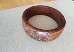 Hand Carved Animal Gemstone Bracelet, Thick Stone Bangle... a finely carved brown stone Bangle... fits a little smaller than normal bangles.. 2.45 inches across opening and 1 inch thick.. in very nice condition... Antique Brown Bracelet Ideal For Gifts, Antique Brown Bracelet Gift, Symbolic Carved Brown Jewelry, Engraved Brown Bracelet Jewelry, Brown Carved Bracelet Jewelry, Adjustable Carved Bracelets, Adjustable Carved Round Bracelets, Adjustable Carved Cuff Bangle Bracelet, Adjustable Carved Cuff Bangle