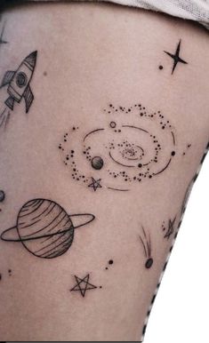 a woman's thigh with an image of planets and stars in the sky on it