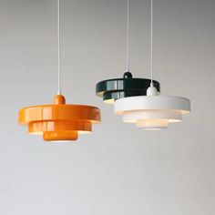 three different colored lights hanging from the ceiling