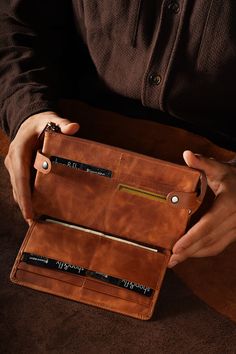 Discover our vintage leather wallet, meticulously crafted to offer both style and practicality. This premium genuine leather wallet is a must-have accessory for those who value quality and sophistication. Handcrafted Genuine Leather: Our wallet is made from high-quality, durable leather, ensuring a timeless and elegant look that stands the test of time. Each wallet is meticulously handcrafted by skilled artisans, giving it a unique touch and superior craftsmanship. The natural grain of the leather adds character, making each piece one-of-a-kind. Large Capacity: Designed with multiple compartments, this wallet provides ample space to hold all your essentials. It features a main compartment for bills, a zippered pocket for coins, and several slots for receipts or small papers. This thoughtfu Character Making, Fly Shop, Large Wallet, Genuine Leather Wallets, Style And Grace, Small Leather Goods, Long Wallet, Elegant Look, Leather Handbag