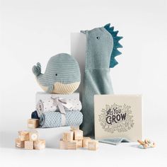 a stuffed animal next to baby blocks and a card that says do you grow?