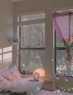 a bedroom with sunlight streaming through the windows and curtains on the window sill in front of the bed