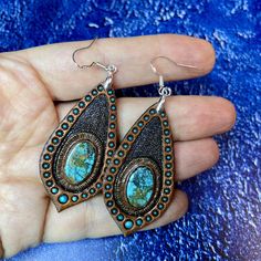 This pair of hand tooled and hand painted leather earrings with beautiful chrysocolla cabochons could become a nice addition to your Boho, hippie, casual, beach, Western clothes. Earrings are made with sterling silver hooks. This piece was MADE TO ORDER, thus in not available. If you would like me to make something for you please contact me for a custom order and we'll discuss the details. I've got plenty of different cabochons in stock, thus I believe we would find something just for you. The p Handmade Leather Turquoise Earrings, Handmade Turquoise Leather Earrings, Handmade Leather Earrings In Turquoise, Artisan Hand-tooled Teardrop Earrings, Handmade Southwestern Copper Jewelry, Bohemian Turquoise Leather Earrings, Adjustable Bohemian Patina Earrings, Southwestern Hand Tooled Earrings For Gift, Southwestern Hand Tooled Earrings As Gift