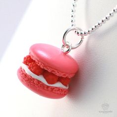 a small pink macaroon necklace on a ball chain