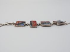 "Listing is for a Unique Art Studio abstract Avant-Garde cloisonné enamel / glass mosaic sterling silver toggle bracelet. Designer signed bracelet with unique microcellular abstract design with 4 sterling silver panels. Bracelet measures 8\" end to end, square panels measure 1\" x 1\", rectangular is 1.3\" x 0.7\". Bracelet is tested positive for silver by acid & magnet testing. Bracelet is engraved on the back. Weight is 82.6 grams. No surface scratches on the glass. Unique one of a kind ha Multicolor Enamel Jewelry With Lobster Clasp, Artistic Red Enamel Jewelry, Collectible Enamel Bracelet Jewelry, Modern Collectible Rectangular Jewelry, Contemporary Adjustable Jewelry For Gifts, Multicolor Cabochon Enamel Jewelry, Multicolor Enamel Cabochon Jewelry, Multicolor Enamel Jewelry With Cabochon, Contemporary Bracelet Jewelry Gift