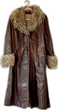 Retro Brown Outerwear With Faux Fur Lining, Retro Brown Fur Coat For Fall, Vintage Leather Fur Coat With Faux Fur Lining, Vintage Brown Outerwear With Faux Fur Trim, Brown Leather Long Fur Coat, Retro Brown Outerwear With Faux Fur Trim, Brown Vintage Fur Coat With Faux Fur Trim, Vintage Leather Fur Coat, Retro Brown Fitted Fur Coat