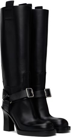 Knee-high buffed calfskin boots in black. · Pin-buckle ankle strap · Webbing pull-loops at collar · D-ring at sides · Topstitching at welt · Stacked calfskin heel with rubber injection · Logo embossed at calfskin sole · Heel: H3.75 Supplier color: Black Black Pins, Burberry Black, Boots Knee, Stirrups, D Ring, High Boots, Knee High Boots, Black Boots, Knee High