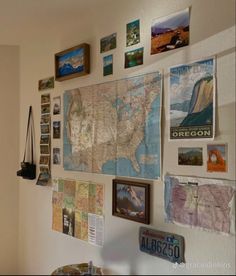 a wall filled with pictures and maps on it